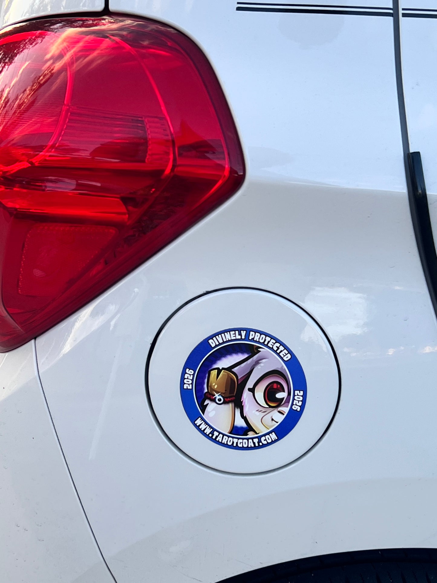 Car magnet with a Tarot Goat Divnely Protectied on a white car's rear light