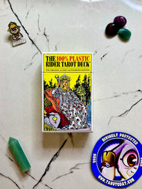 the 100% plastic rider the original and only authorized edition on a marble table with crystals and a taro goat magnet