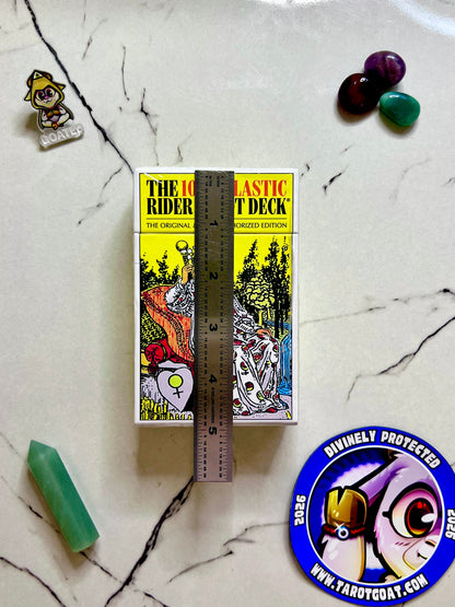 A full tarot cards, deck being measured by a ruler on a marble table with crystals for a ritual