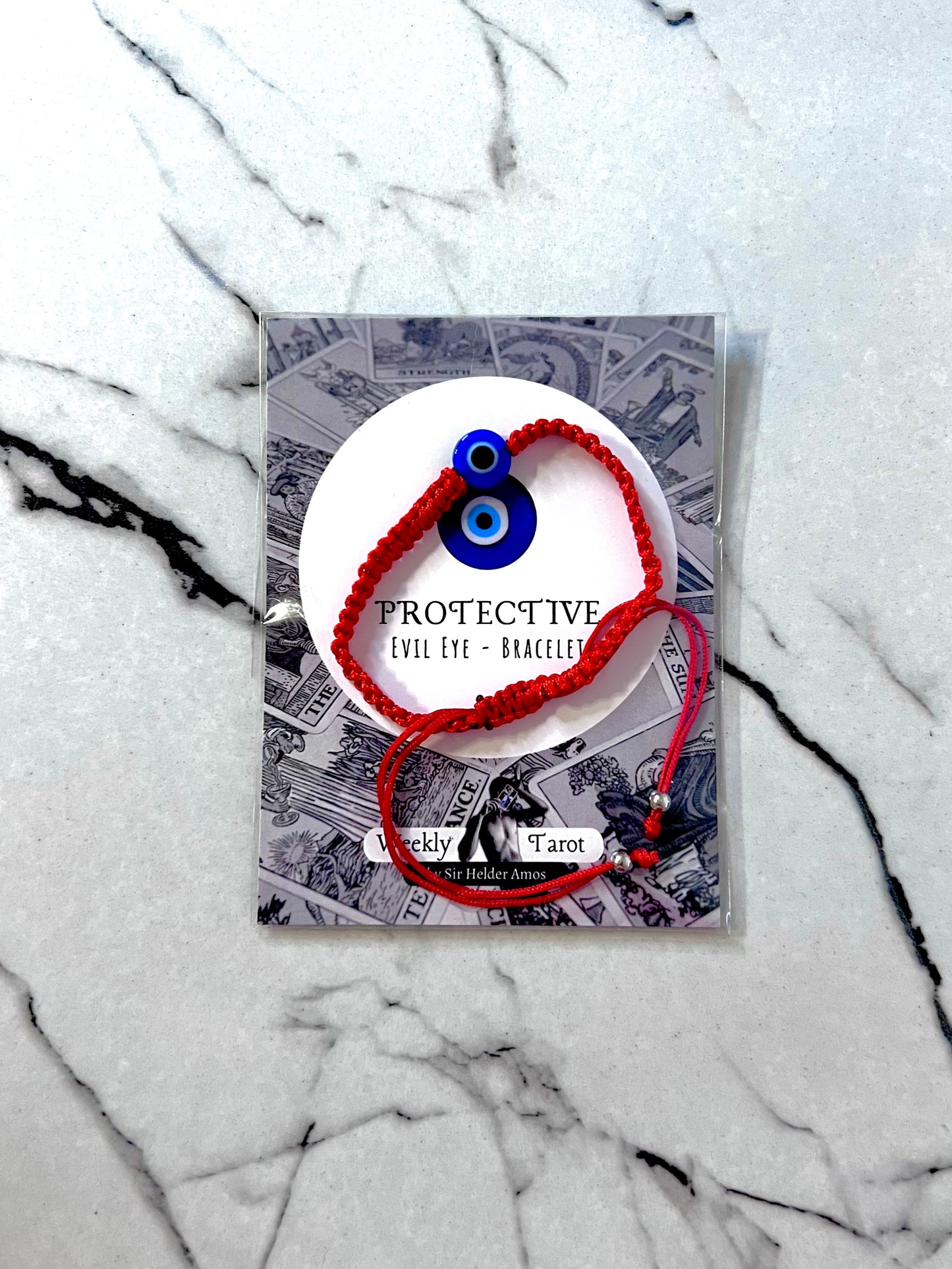 Protective evil eye bracelet (red) on a marble surface