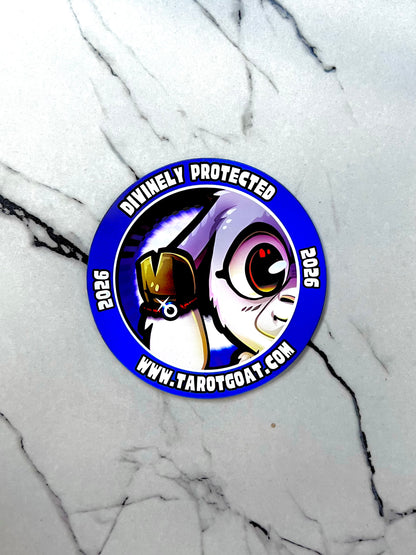 Circular car  fridge magnet  with Tarot Goat wearing a red evil eye protection bracelet and text 'Divinely Protected 2025' on a marble background