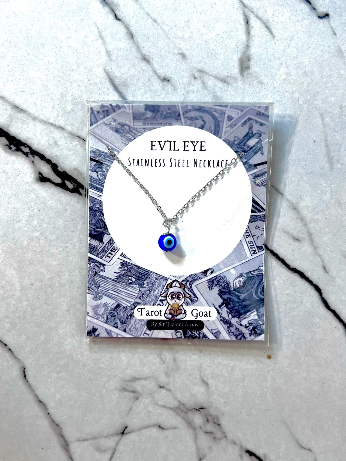 Stainless Steel Evil Eye necklace on a branded card with a marble background