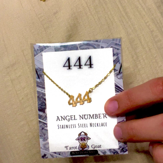 Model wearing a 444 number cecklace holding the angel number packaging with brand tarot goat for men and women 