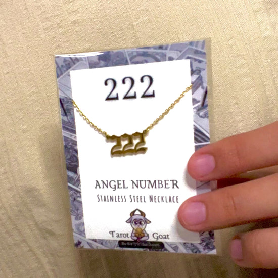 Video of a person displaying the 222 angel number necklace made of stainless steel