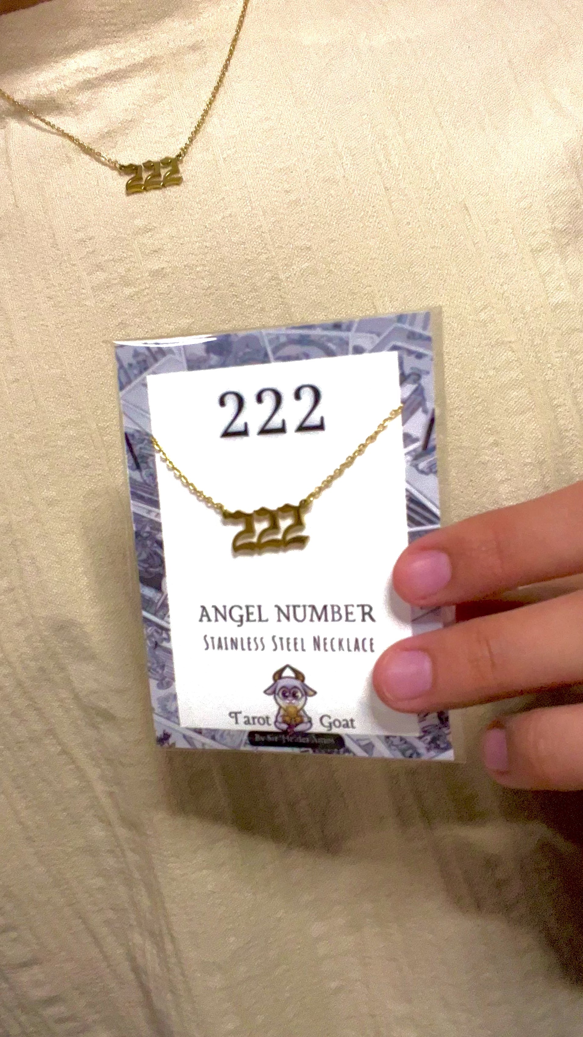 Video of a person displaying the 222 angel number necklace made of stainless steel